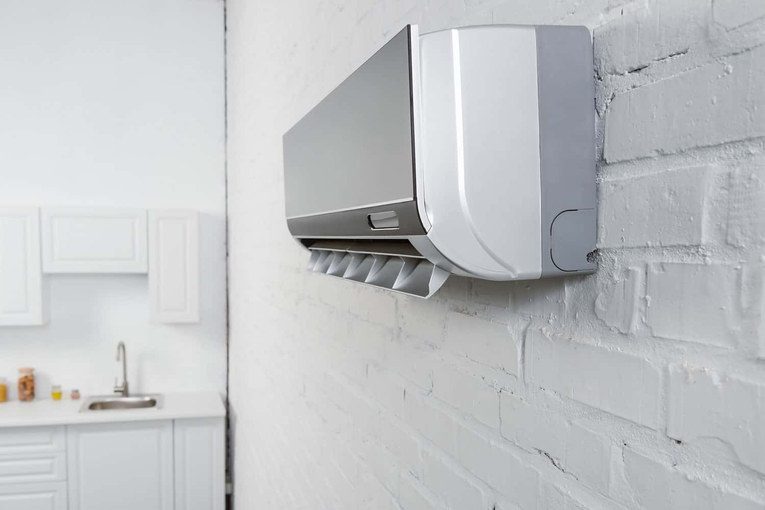 Modern wall-mounted air conditioning unit in a clean, bright room.